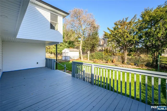 a view of a wooden deck and a yard