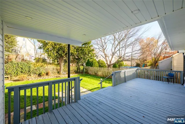 a view of swimming pool with deck and yard