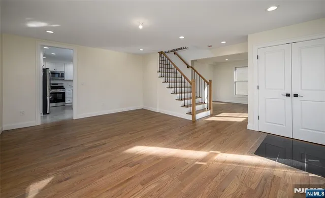 a view of entryway and hall with wooden floor