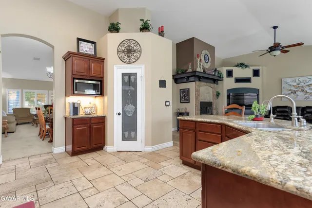 a very nice looking open kitchen with stainless steel appliances granite countertop a stove and a cabinets