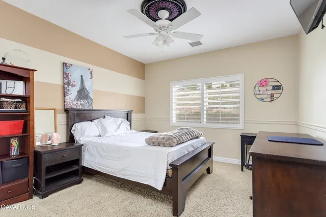 a bathroom with a granite countertop double vanity sink and a mirror