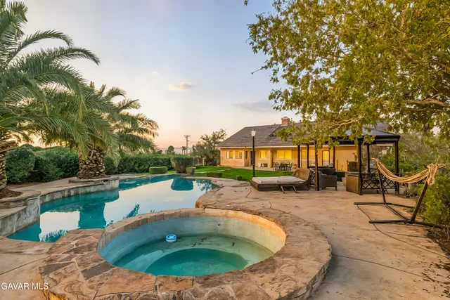 swimming pool view with a seating space