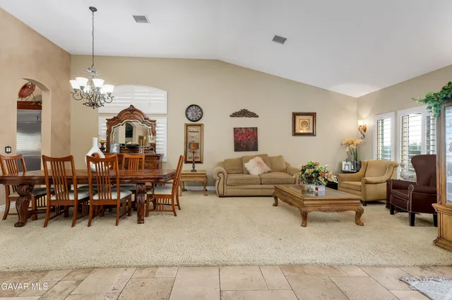 a living room with lots of furniture and a chandelier