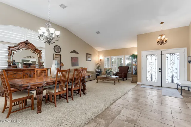 a view of a dining room with furniture and a chandelier