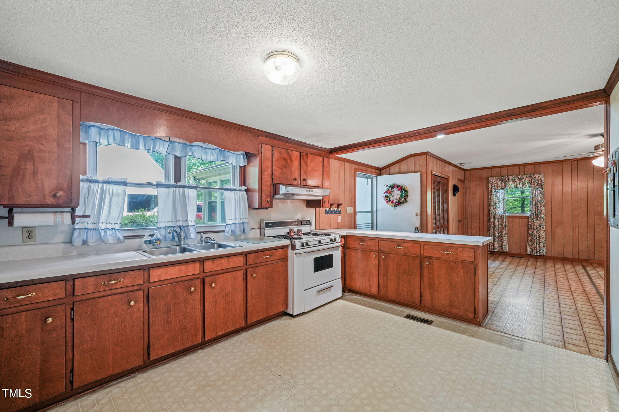 3015 Old Raleigh Road Apex, NC 27502 - Photo 15 of 47 a large kitchen with stainless steel appliances granite countertop a large window a sink and a counter space