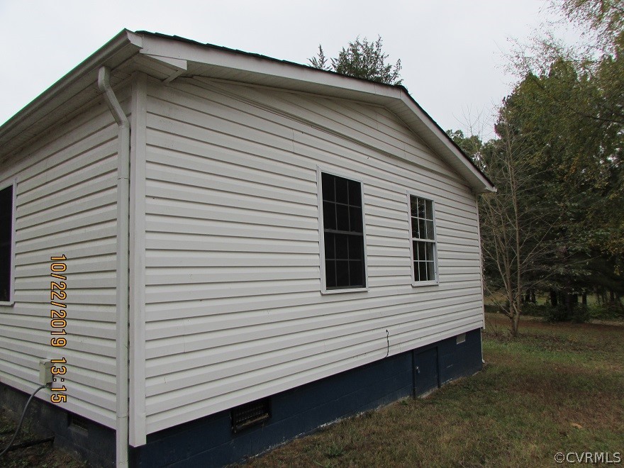14704 Madison Road Dewitt, VA 23840 - Photo 7 of 20 a view of a white house with a small space