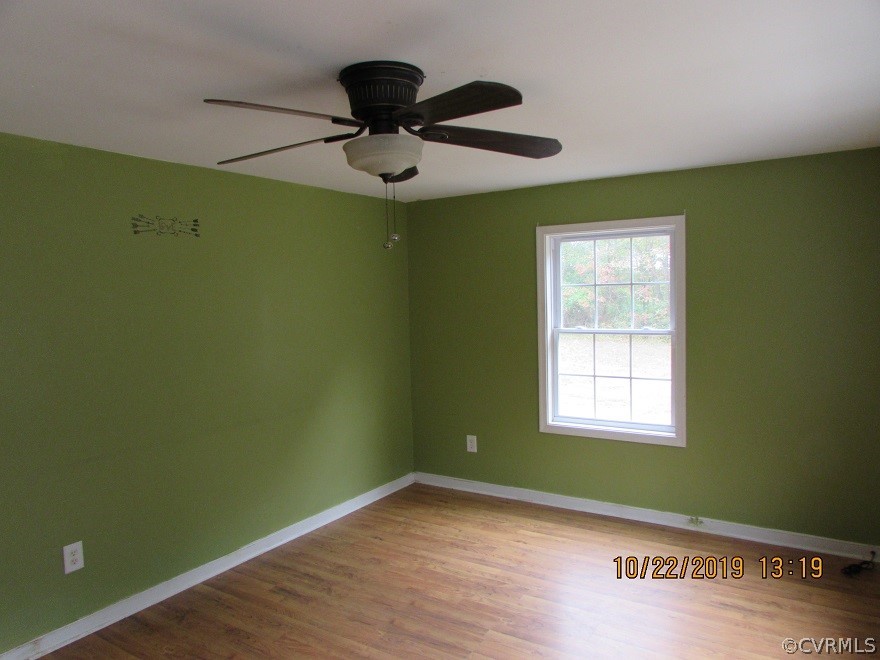 14704 Madison Road Dewitt, VA 23840 - Photo 8 of 20 view of empty room with wooden floor and fan