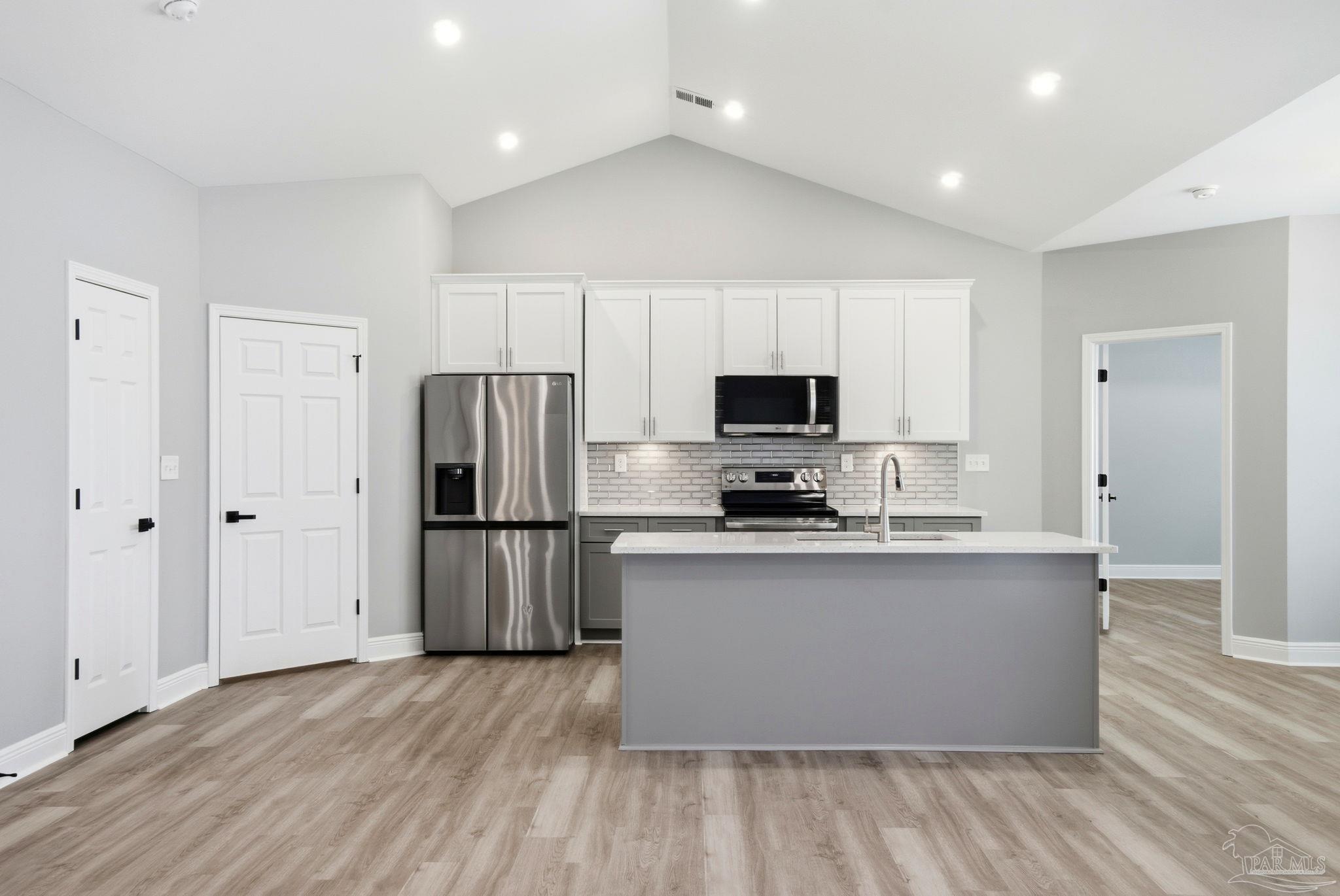 5712 Riviera Drive Milton, FL 32583 - Photo 13 of 41 a kitchen with stainless steel appliances a refrigerator and a stove top oven