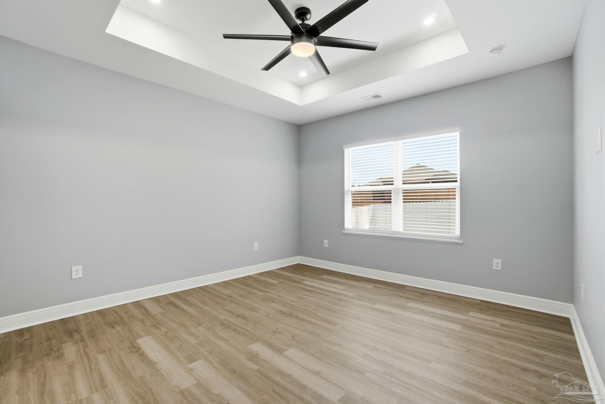 5712 Riviera Drive Milton, FL 32583 - Photo 19 of 41 an empty room with a window and ceiling fan