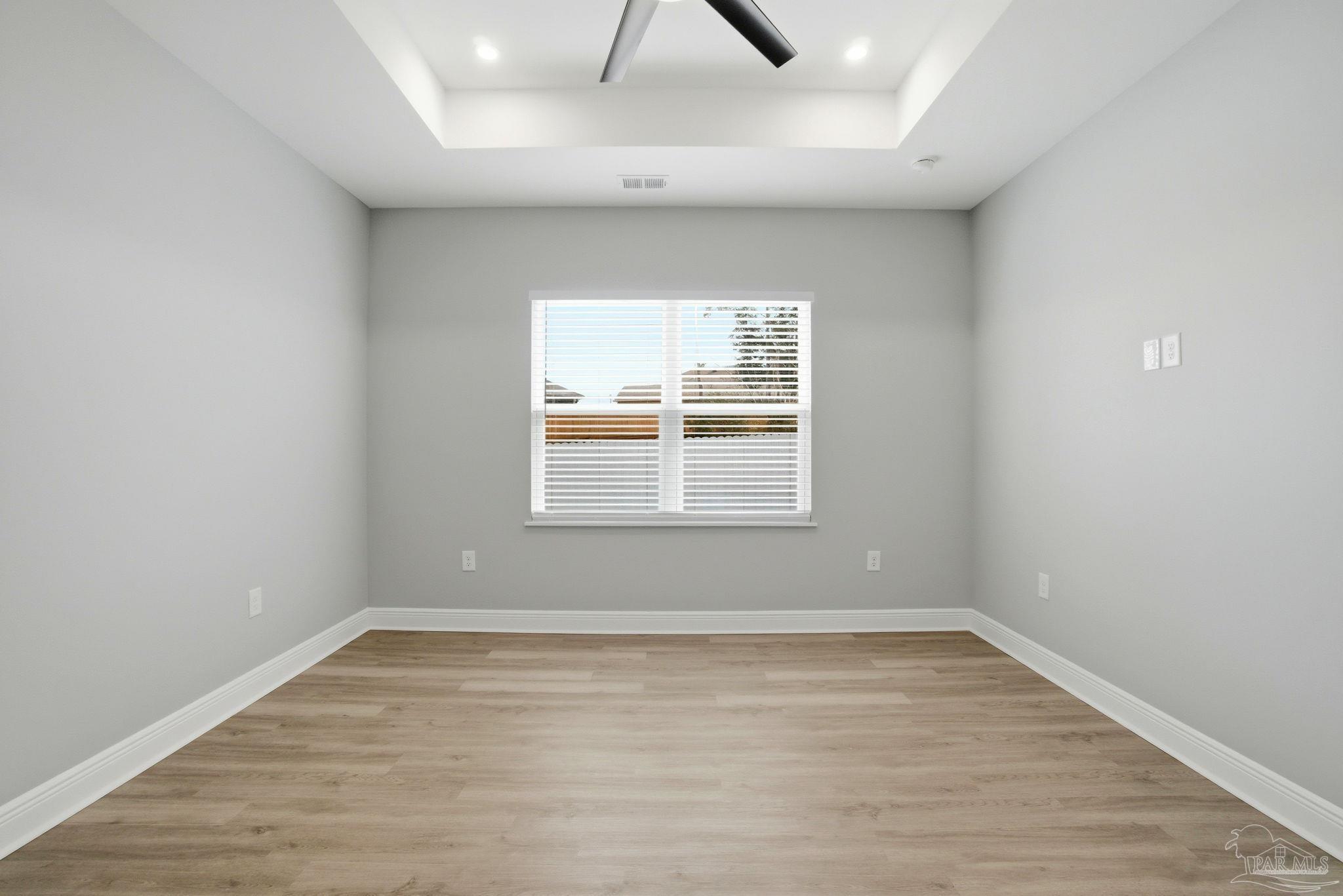 5712 Riviera Drive Milton, FL 32583 - Photo 20 of 41 wooden floor in an empty room with a window