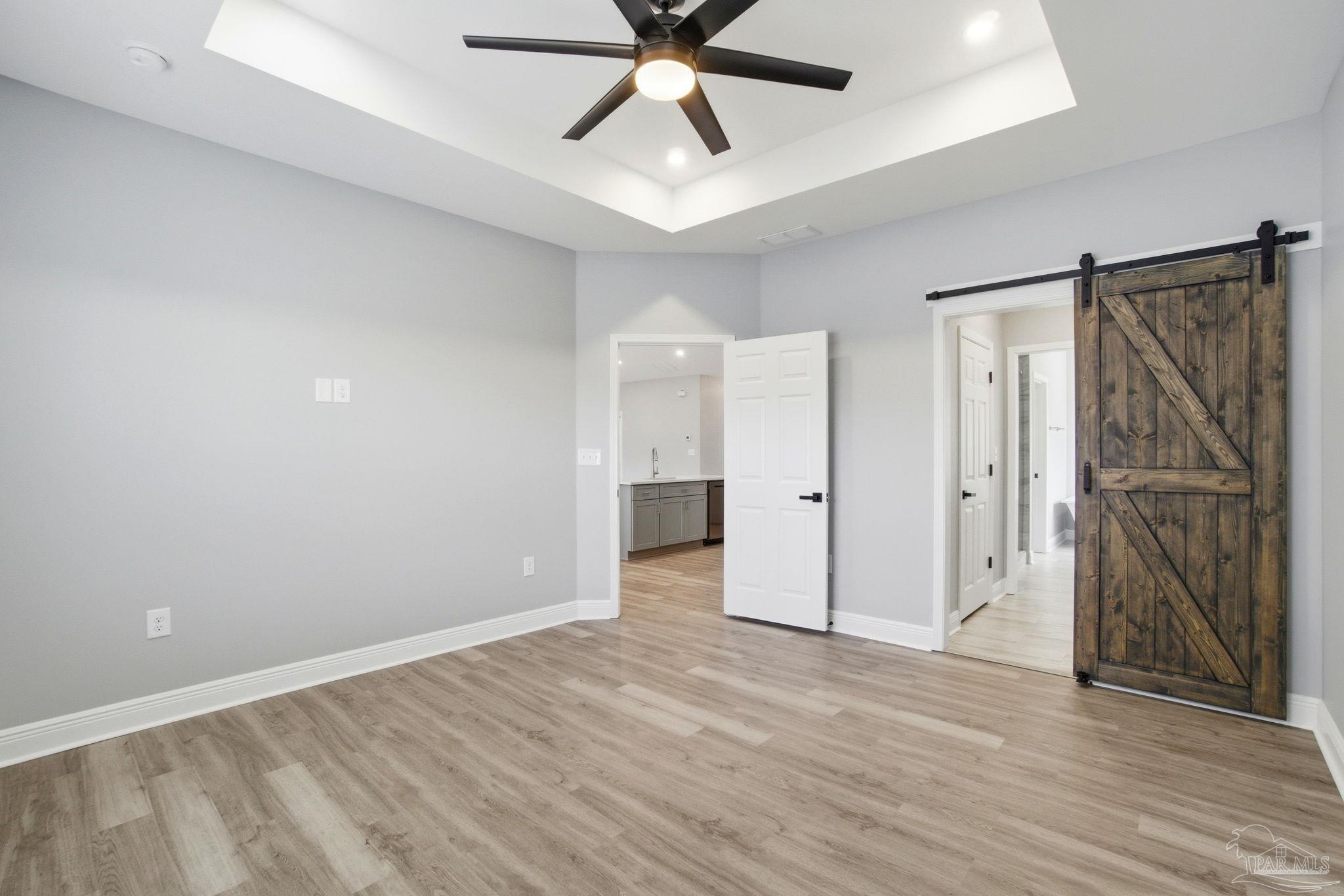 5712 Riviera Drive Milton, FL 32583 - Photo 21 of 41 wooden floor in an empty room