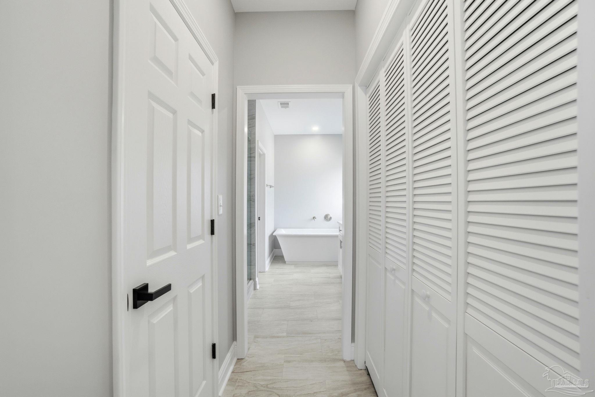 5712 Riviera Drive Milton, FL 32583 - Photo 22 of 41 a view of a bathroom from a hallway