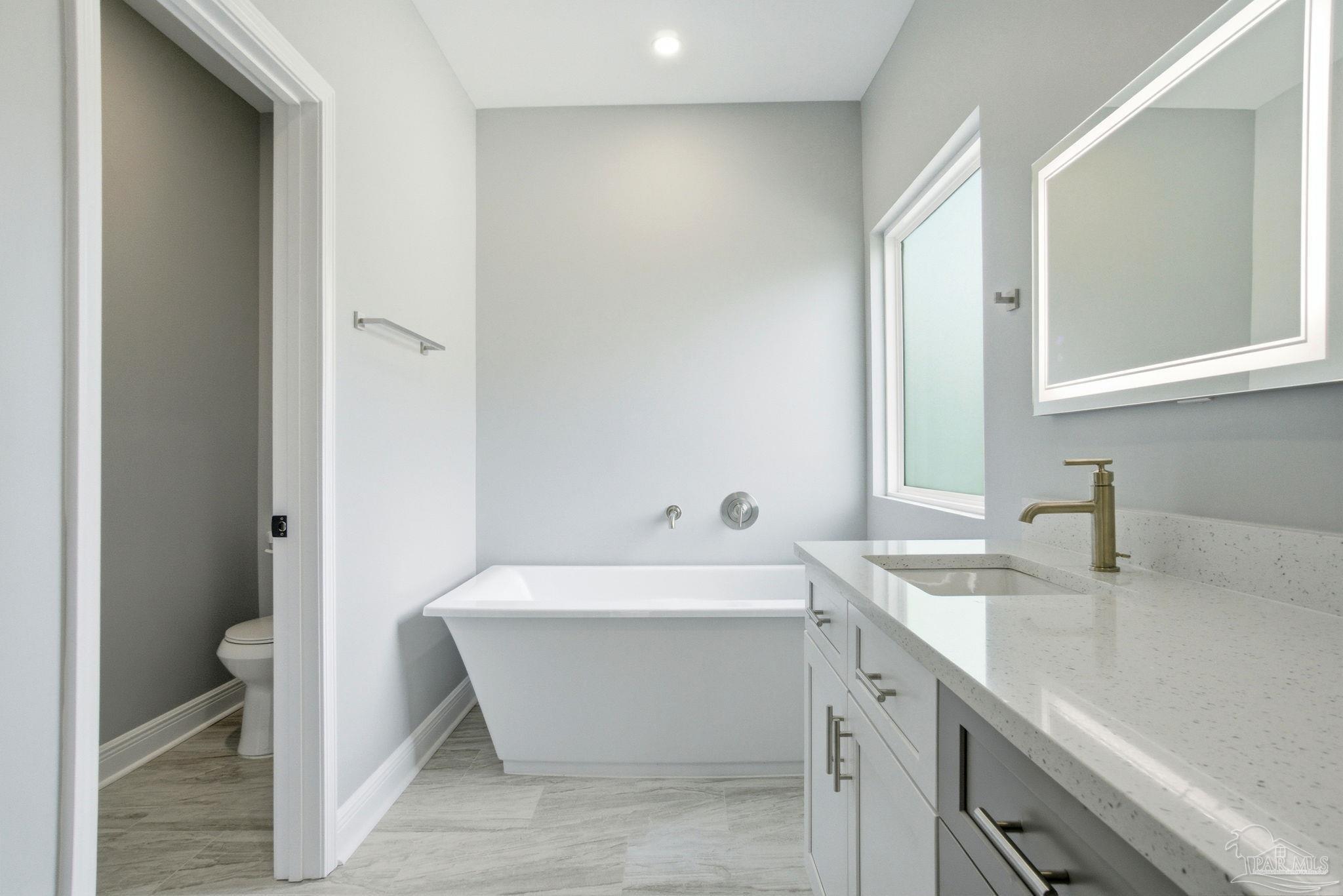 5712 Riviera Drive Milton, FL 32583 - Photo 25 of 41 a bathroom with a sink and a bathtub