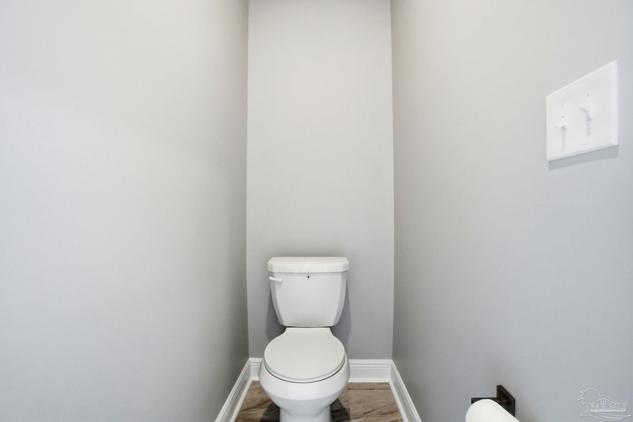 5712 Riviera Drive Milton, FL 32583 - Photo 26 of 41 a white toilet sitting in a bathroom