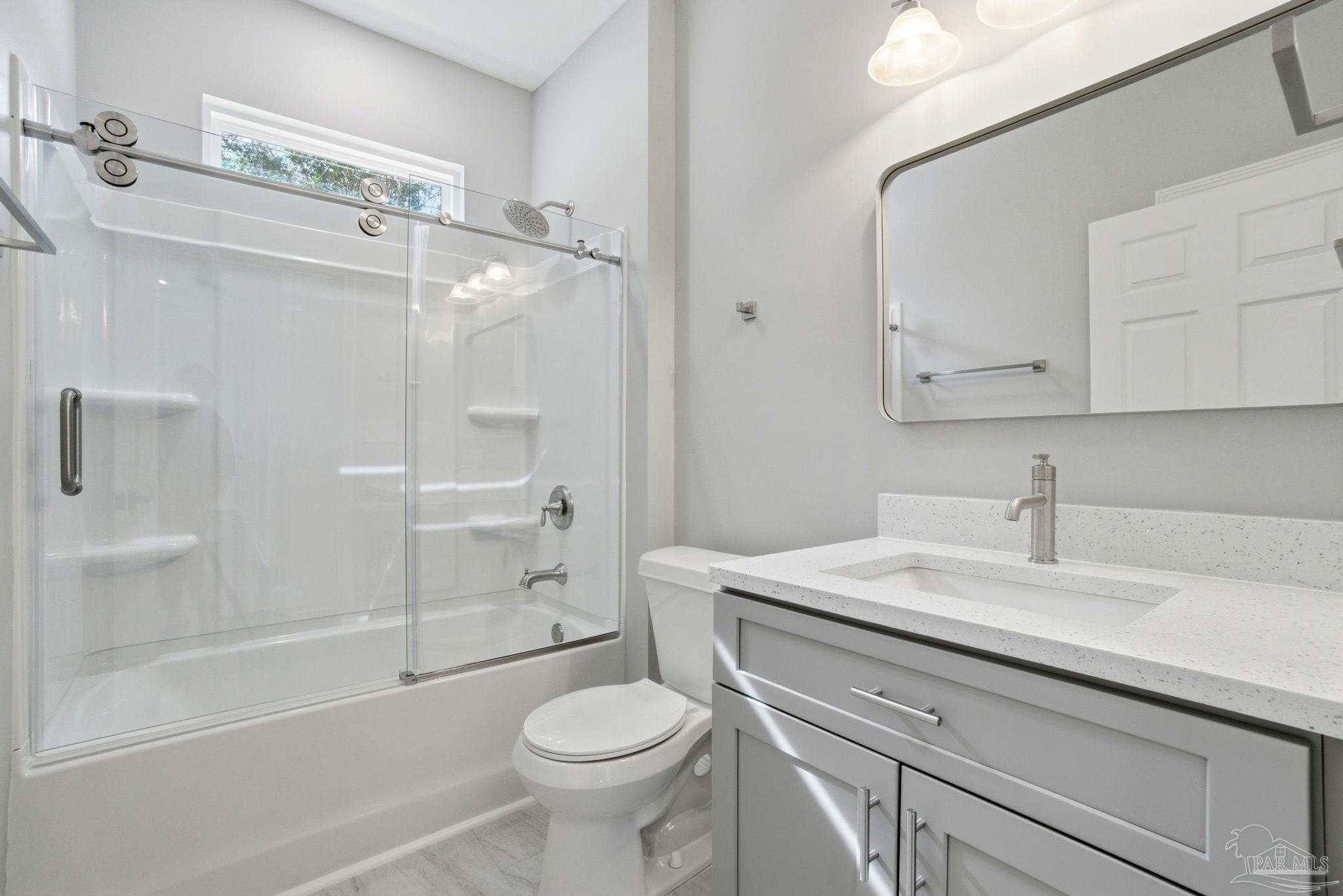 5712 Riviera Drive Milton, FL 32583 - Photo 33 of 41 a bathroom with a sink a toilet and shower