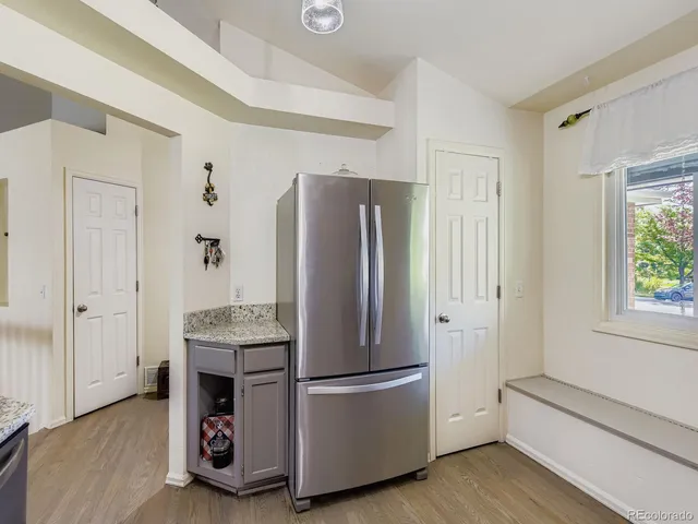 a kitchen with stainless steel appliances granite countertop a refrigerator and a stove top oven