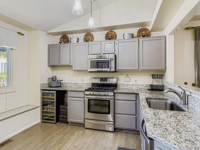 a kitchen with cabinets appliances and a sink