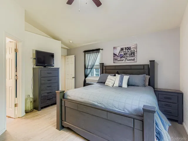 a bedroom with a bed and a television