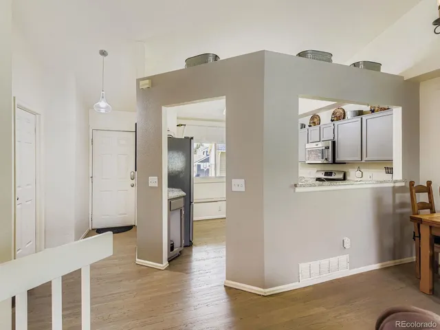 a view of a refrigerator in kitchen and wooden floor