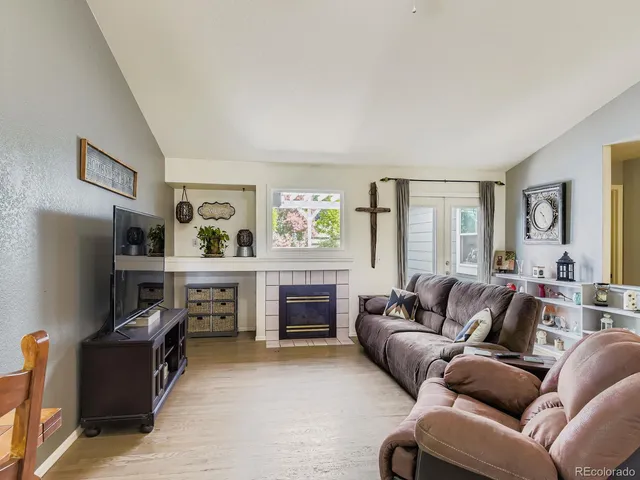 a living room with furniture and a fireplace