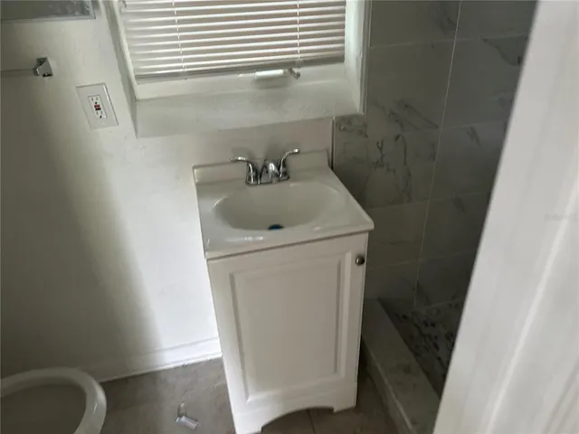 a utility room with sink dryer and washer