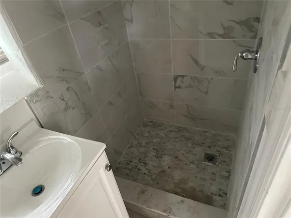 a bathroom with a sink and shower