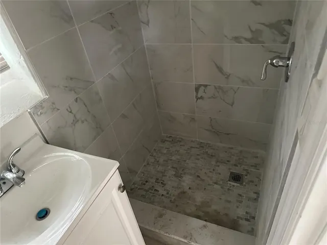a bathroom with a sink and shower