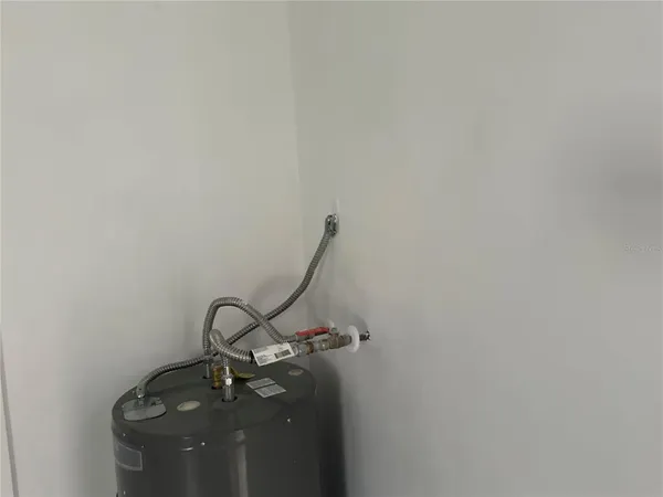 a room with water heater and wooden floor