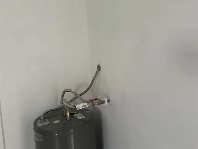 a room with water heater and wooden floor