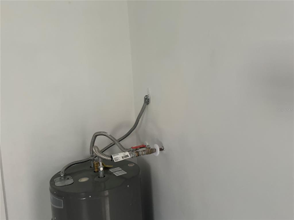 6179 West Star Court Homosassa, FL 34446 - Photo 20 of 21 a room with water heater and wooden floor