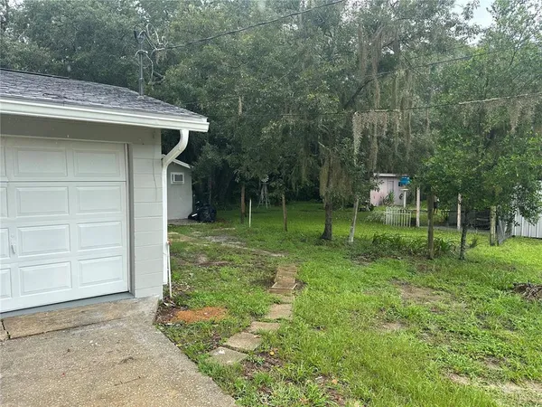 a view of a wooden house with a small yard