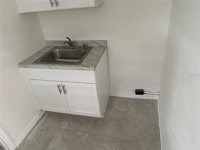 a kitchen with a sink and cabinets