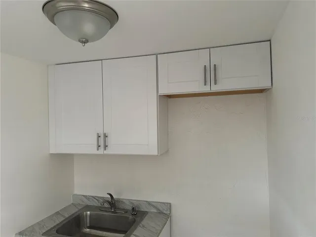 a kitchen with cabinets and a sink