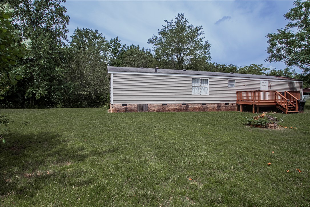 169 West Bagwell Road Liberty, SC 29657 - Photo 5 of 29 A well-maintained manufactured home nestled amidst lush green foliage offers peaceful outdoor living.
