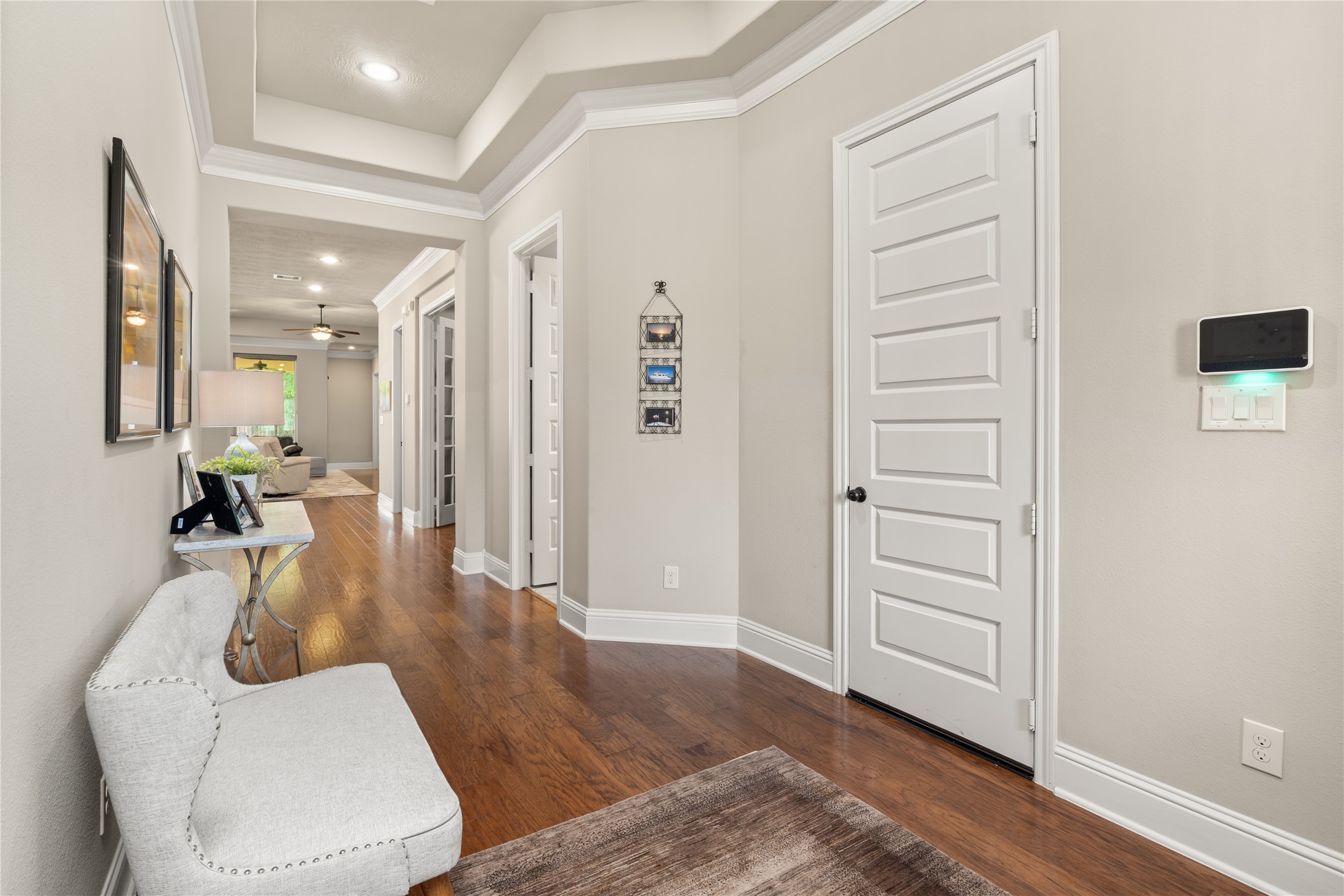 19813 Cullen Ridge Drive Porter, TX 77365 - Photo 8 of 44 This inviting foyer, featuring elegant hardwood floors seamlessly connects to the living space and includes convenient access to the garage, offering both functionality and charm.