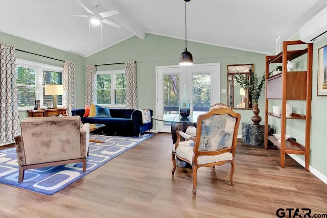 a living room with furniture windows and wooden floor