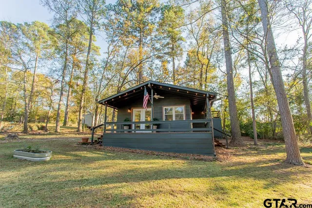 a view of a house with a yard and tree s