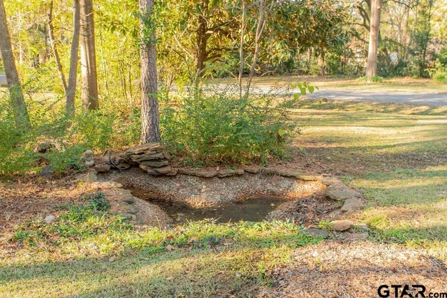 a view of a house with a yard and tree s