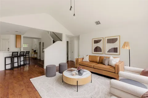 a living room with furniture and a floor to ceiling window