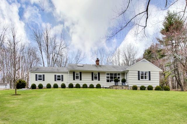 197 Georgetown Road Weston, CT 06883 - Photo 1 of 1 a front view of a house with a garden