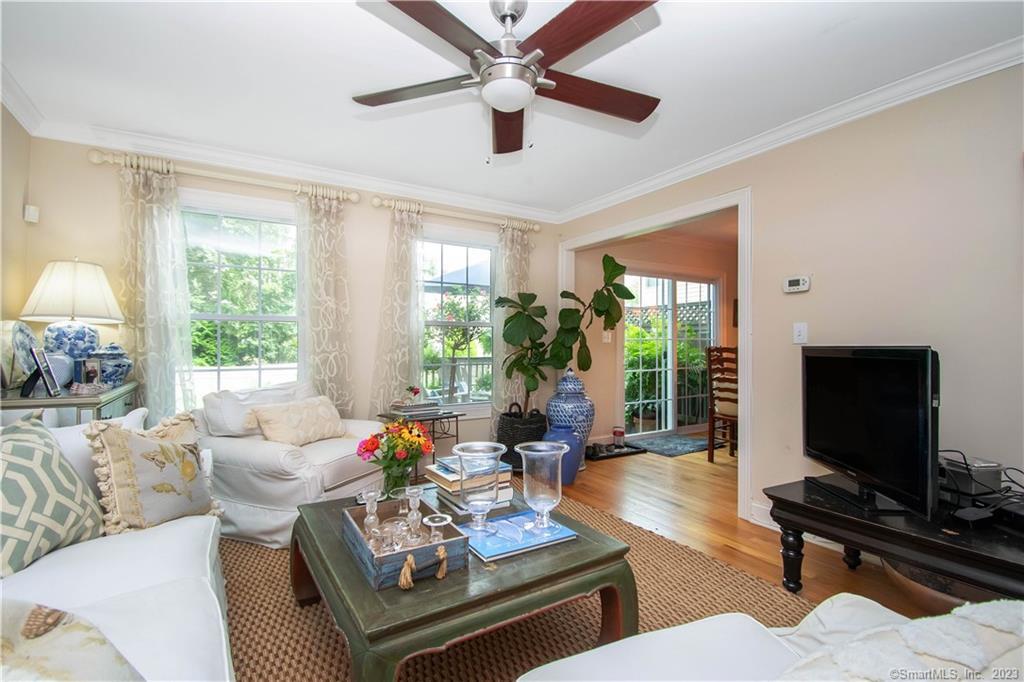 469 South Benson Road Fairfield, CT 06824 - Photo 12 of 20 a living room with furniture a flat screen tv and a large window