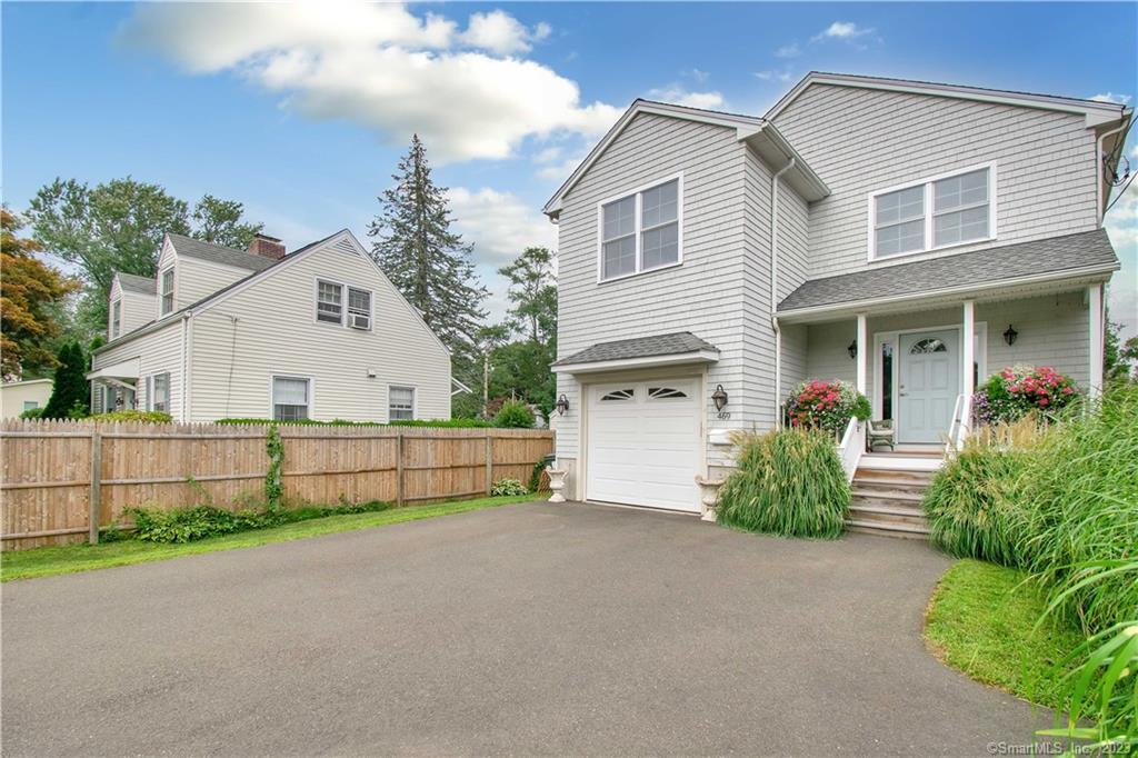 469 South Benson Road Fairfield, CT 06824 - Photo 4 of 20 a view of a white house next to a yard and road