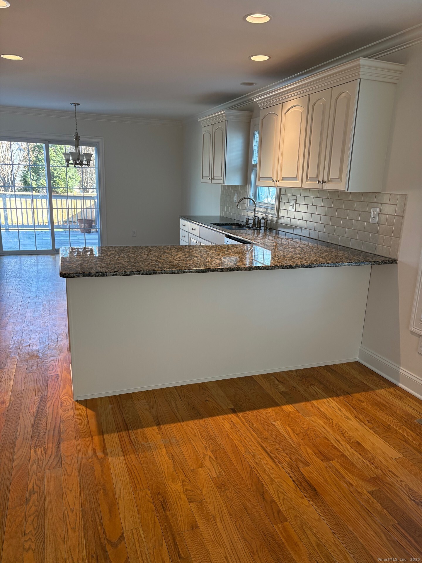 469 South Benson Road Fairfield, CT 06824 - Photo 8 of 20 a view of kitchen with granite countertop cabinets and wooden floor