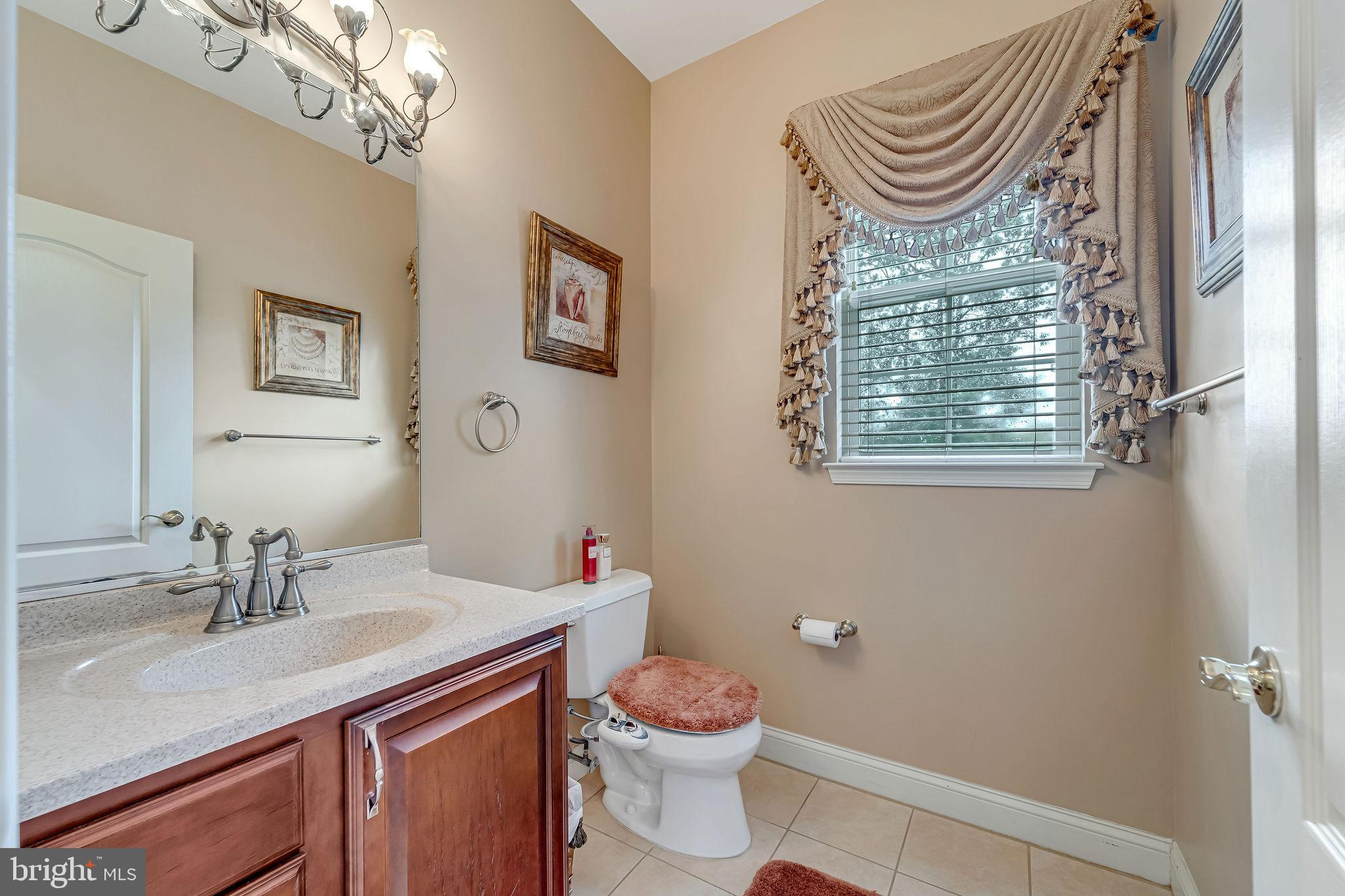 2 Lansbrook Court Sewell, NJ 08080 - Photo 17 of 44 a bathroom with a sink a toilet and a mirror
