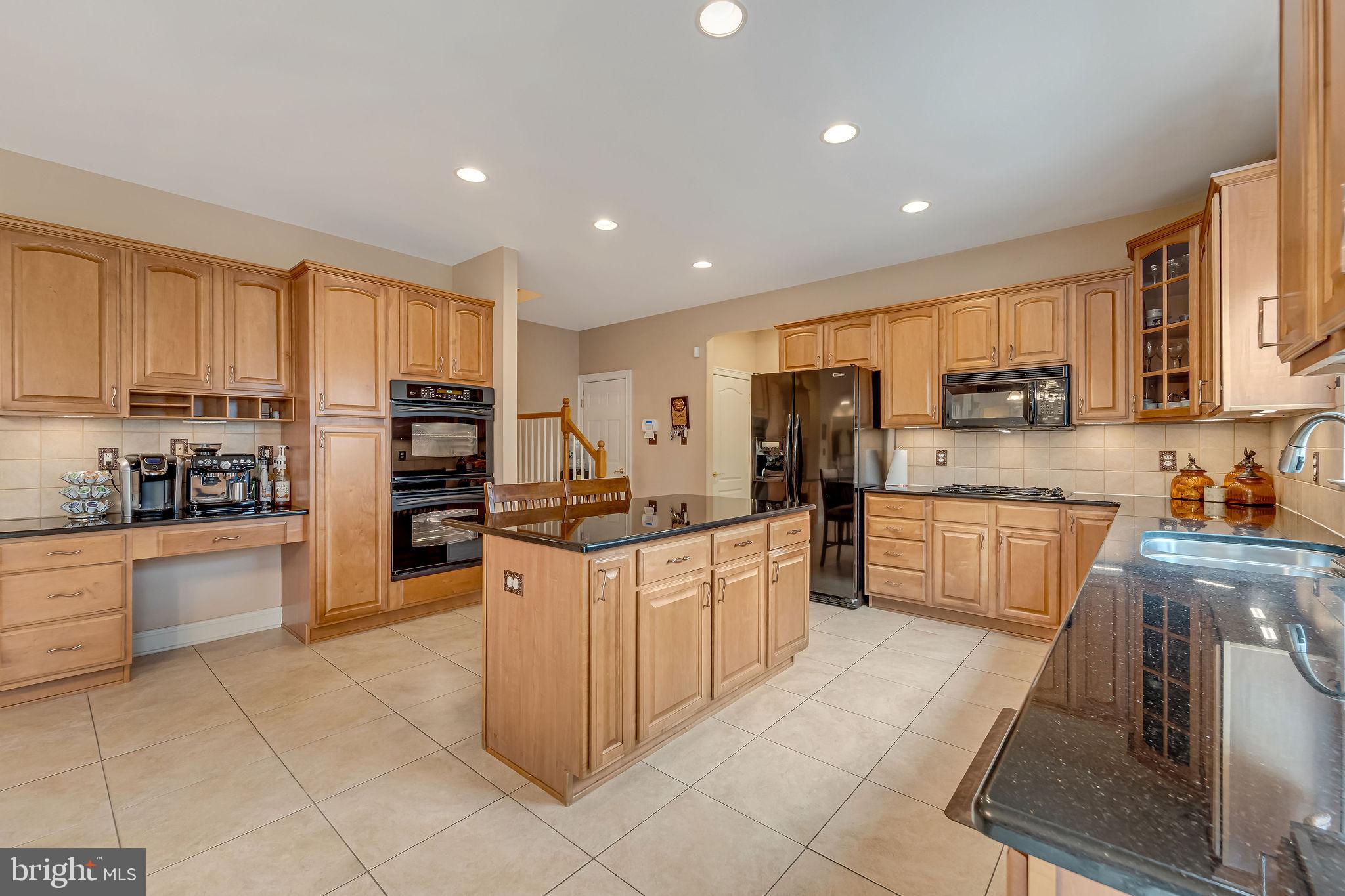 2 Lansbrook Court Sewell, NJ 08080 - Photo 23 of 44 a kitchen with stainless steel appliances a refrigerator sink stove microwave and cabinets