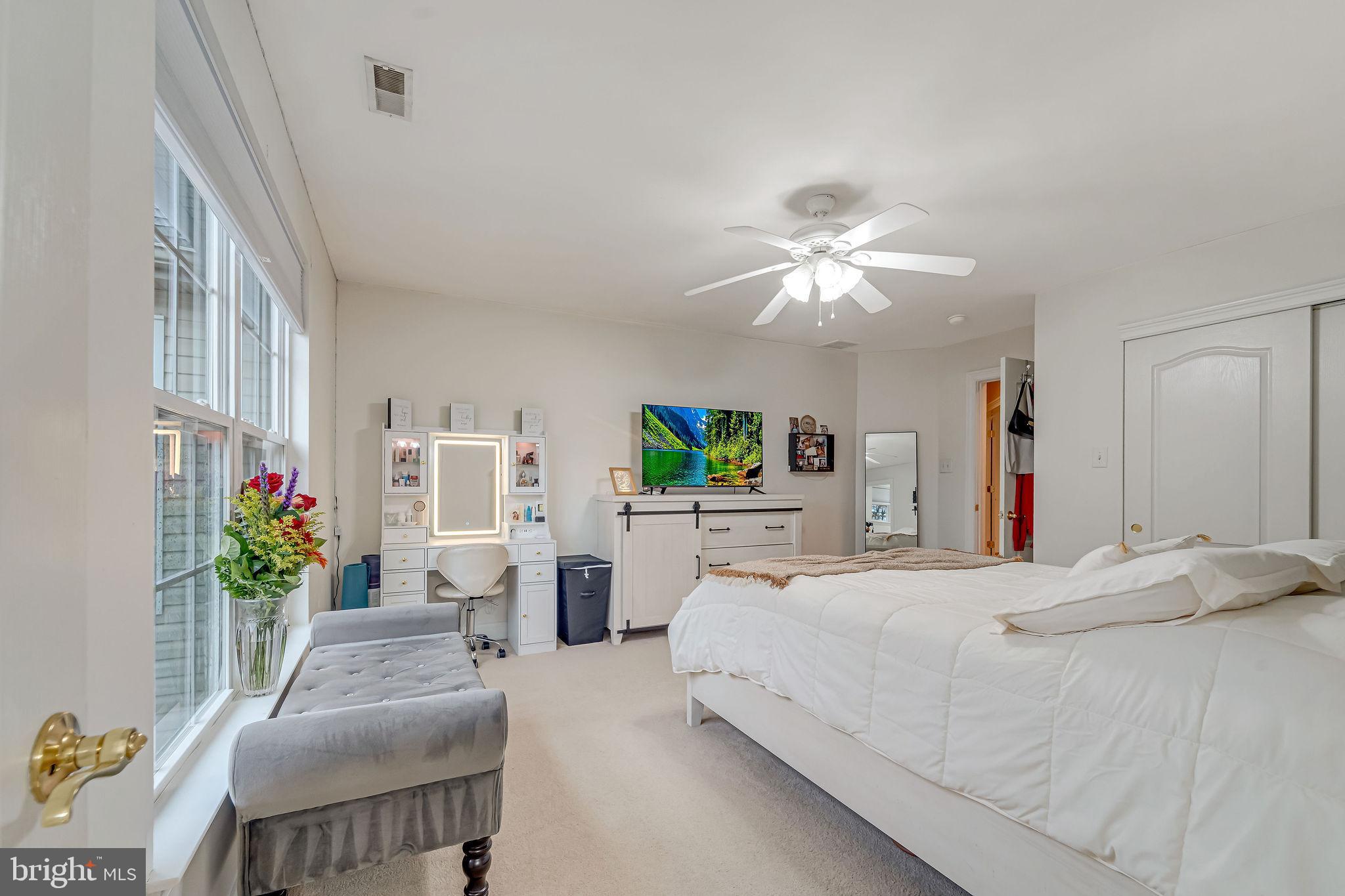 2 Lansbrook Court Sewell, NJ 08080 - Photo 33 of 44 a bedroom with a bed potted plant on the dresser and a chandelier
