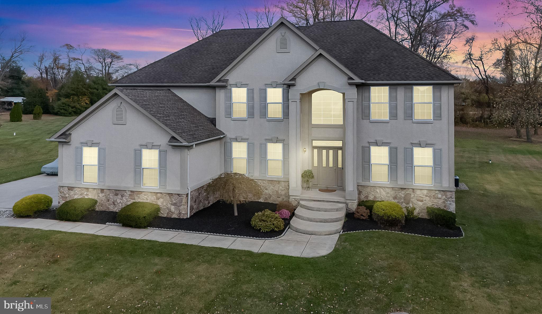 2 Lansbrook Court Sewell, NJ 08080 - Photo 10 of 44 a front view of a house with a garden and trees