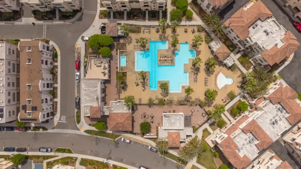 an aerial view of residential houses with outdoor space