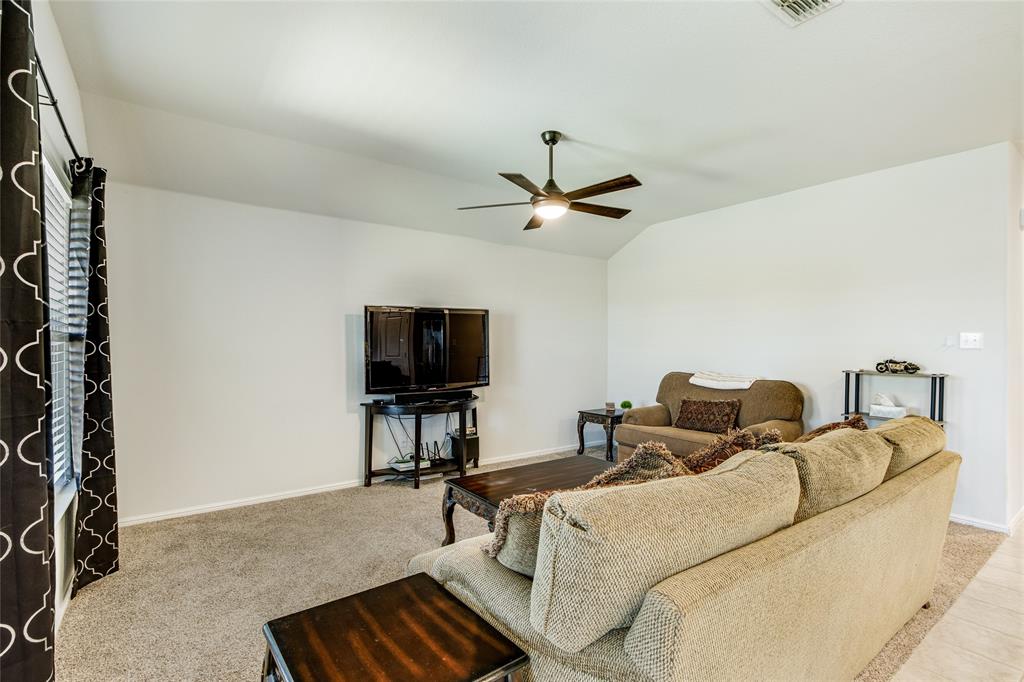 16516 Portage Street Justin, TX 76247 - Photo 13 of 29 a living room with furniture and a flat screen tv