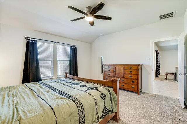 a bedroom with a bed and a large mirror